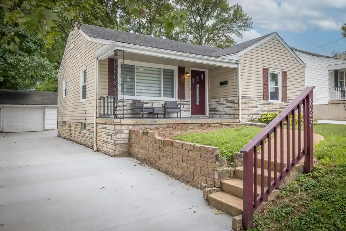 The exterior of the Short-Term Rental Property in St. Charles, Missouri, features a long, newly-poured driveway, and steps leading to the front door.